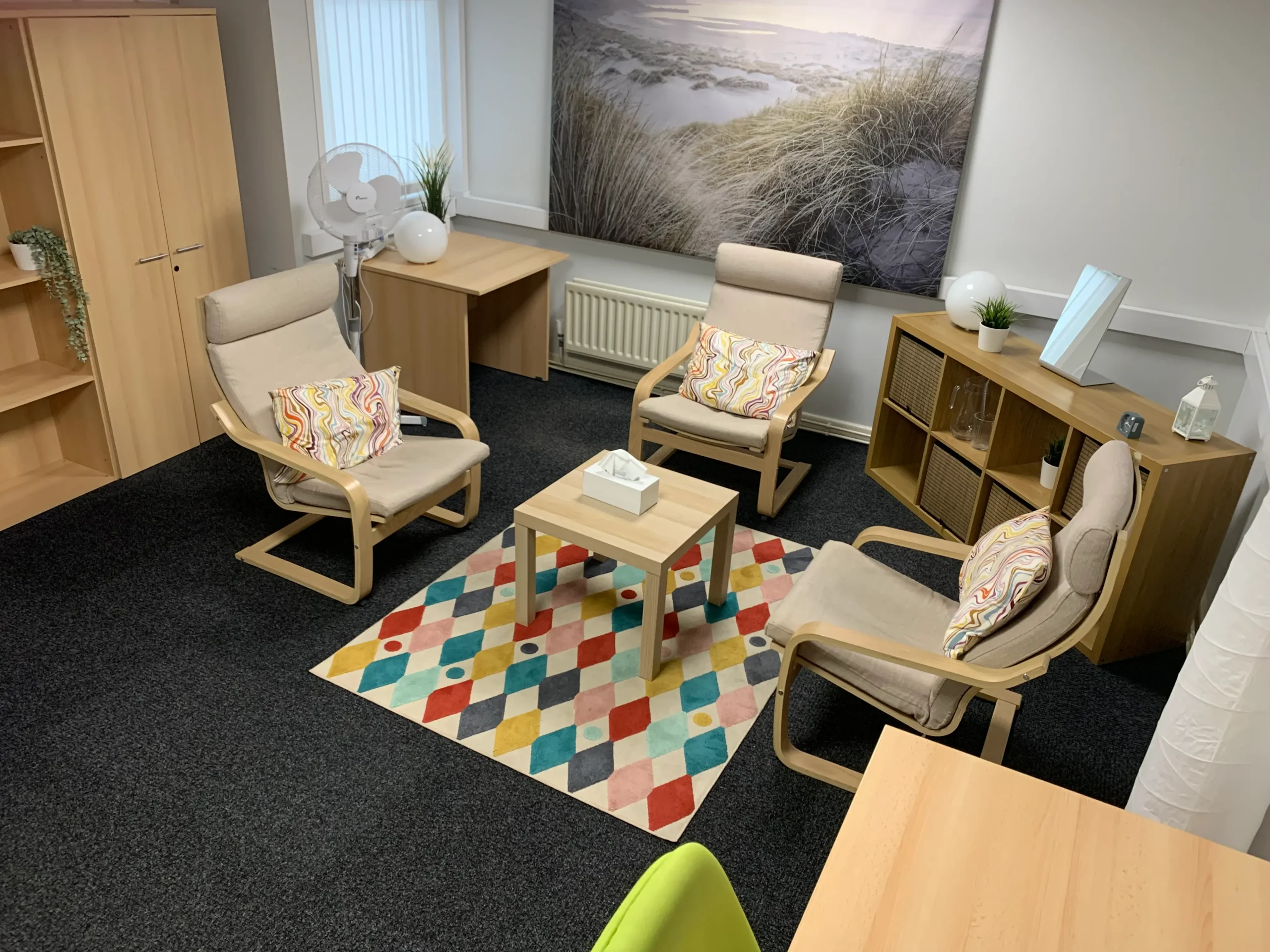 IMG_3993_1 Comfortable counselling room with chairs and colorful rug.