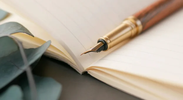 pexels-towfiqu-barbhuiya-3440682-11154571 Open notebook with a fountain pen.