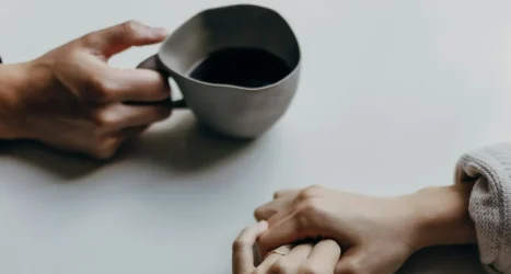 priscilla-du-preez-gFgKa_ftMOE-unsplash Two people holding hands across a table